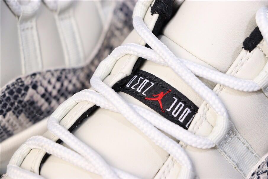 Air Jordan 11 Retro Low White Black Snakeskin Sneakers - product image from the listing.