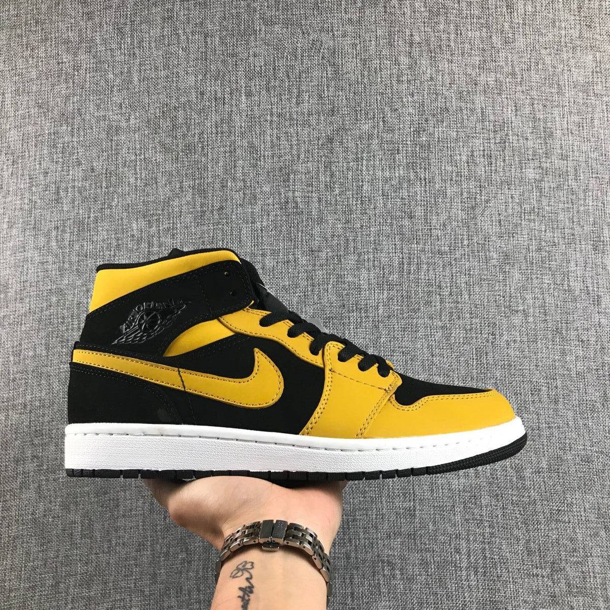 Air Jordan 1 Mid Sneakers in Black and Yellow - product image from the listing.