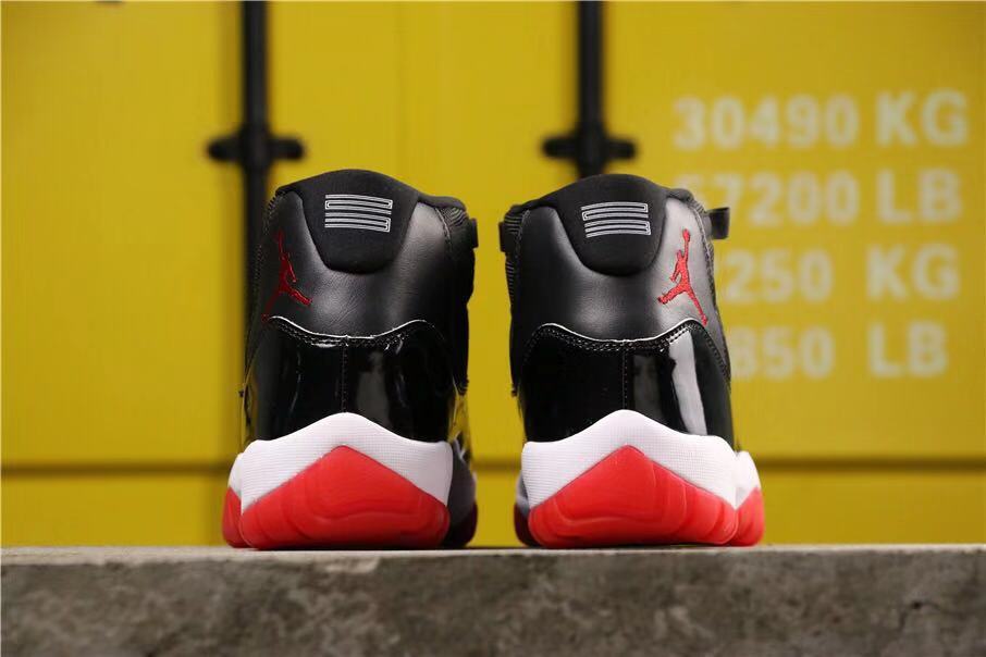 Air Jordan 11 Retro Bred High-Top Sneakers in Black and Red - product image from the listing.