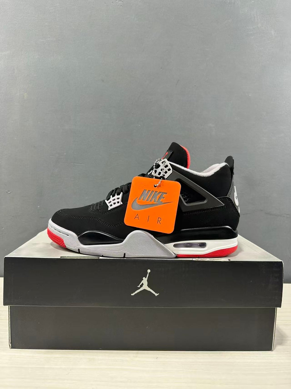 Air Jordan 4 Retro Bred Black Red Sneakers IX8180-001 - product image from the listing.