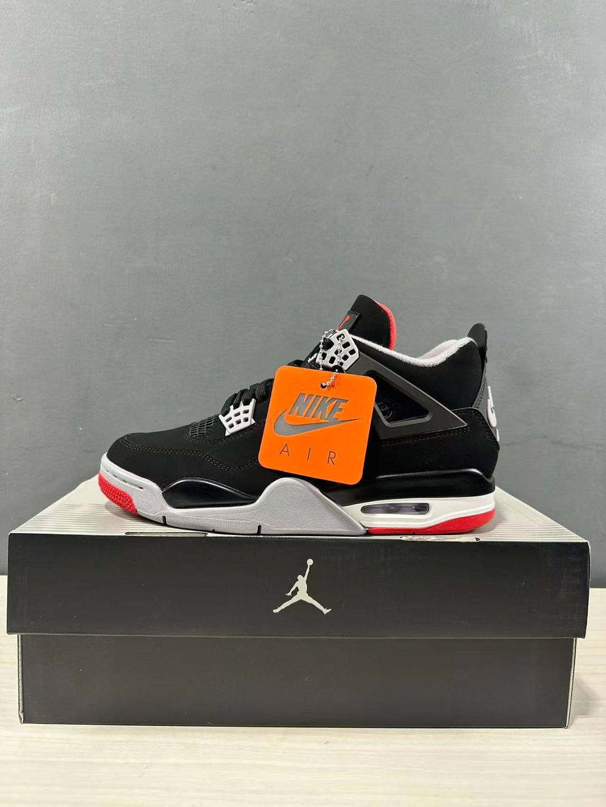 Air Jordan 4 Retro Bred Black Red Sneakers IX8180-001 - product image from the listing.