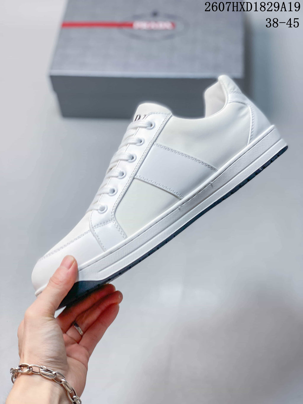 Prada Downtown Low-Top Sneakers in White Leather 2607HXD1829A19 - product image from the listing.