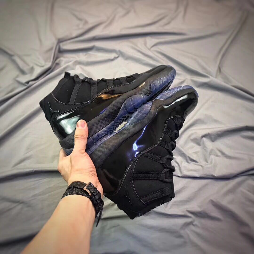 Air Jordan 11 Cap and Gown High-Top Sneakers in Black - product image from the listing.