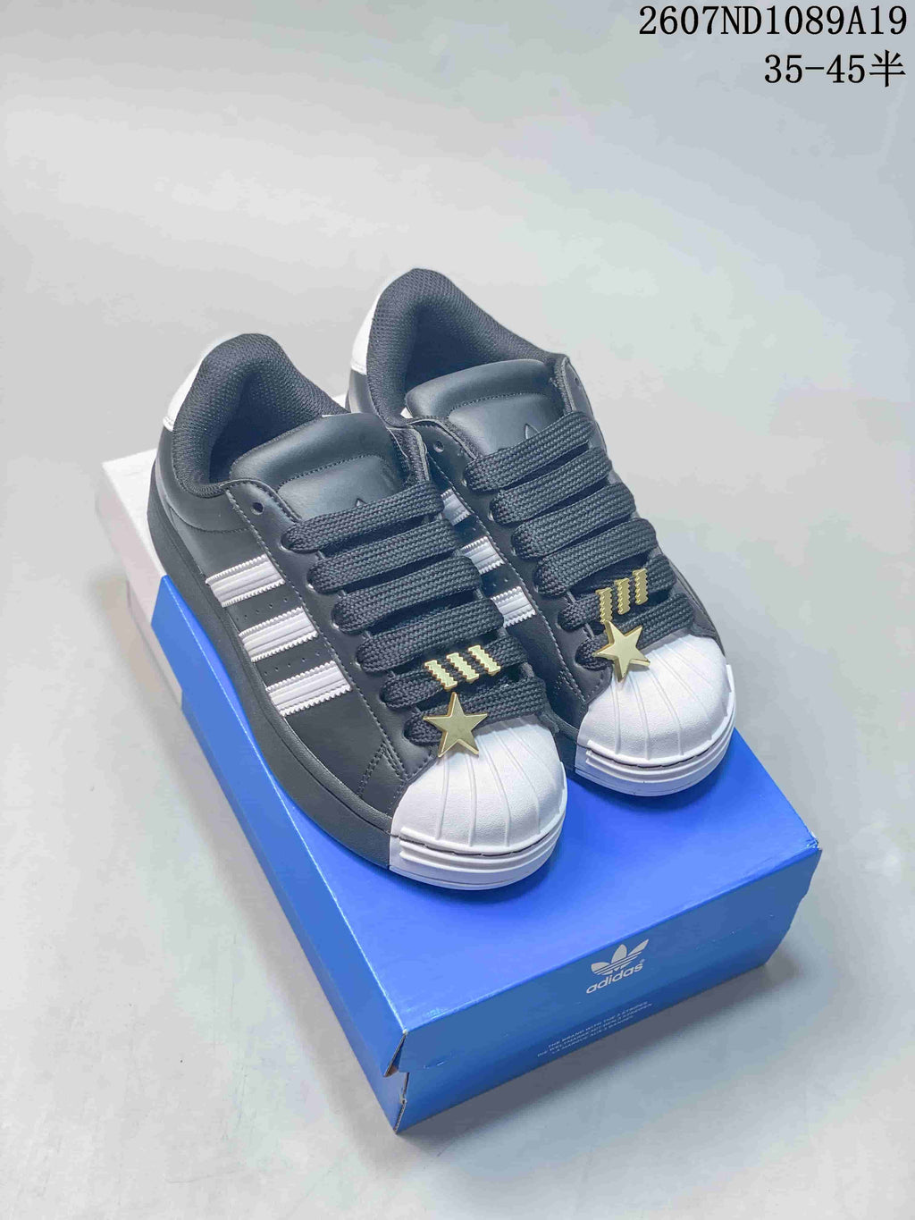 adidas Superstar Shell-Toe Sneakers in Black and White - product image from the listing.
