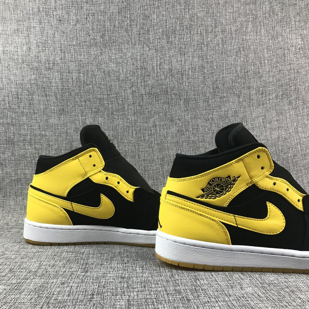 Air Jordan 1 Mid Sneakers in Black and Yellow - product image from the listing.