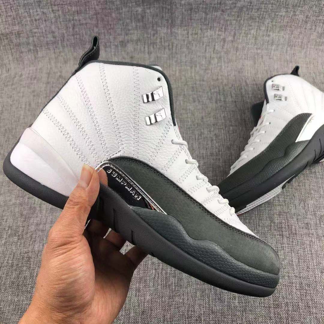 Air Jordan 12 Retro Taxi White Black Sneakers - product image from the listing.