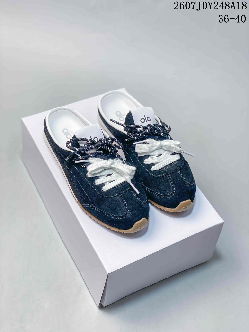 alo Sunset Mule Sneakers in Pink, in Navy and Cream - product image from the listing.