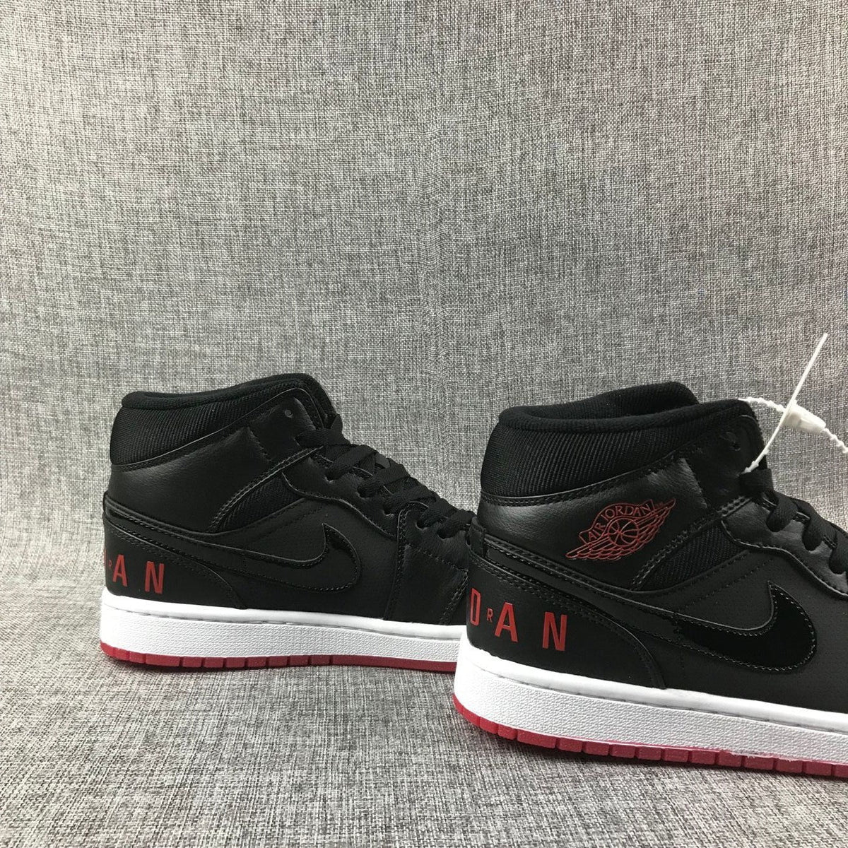 Air Jordan 1 Mid High-Top Sneakers in Black Red White - product image from the listing.