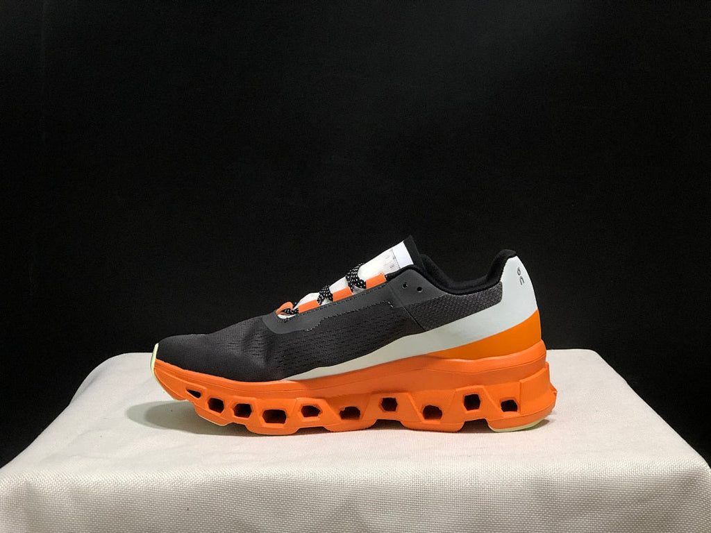On Cloudmonster Running Shoes in Black Orange - product image from the listing.