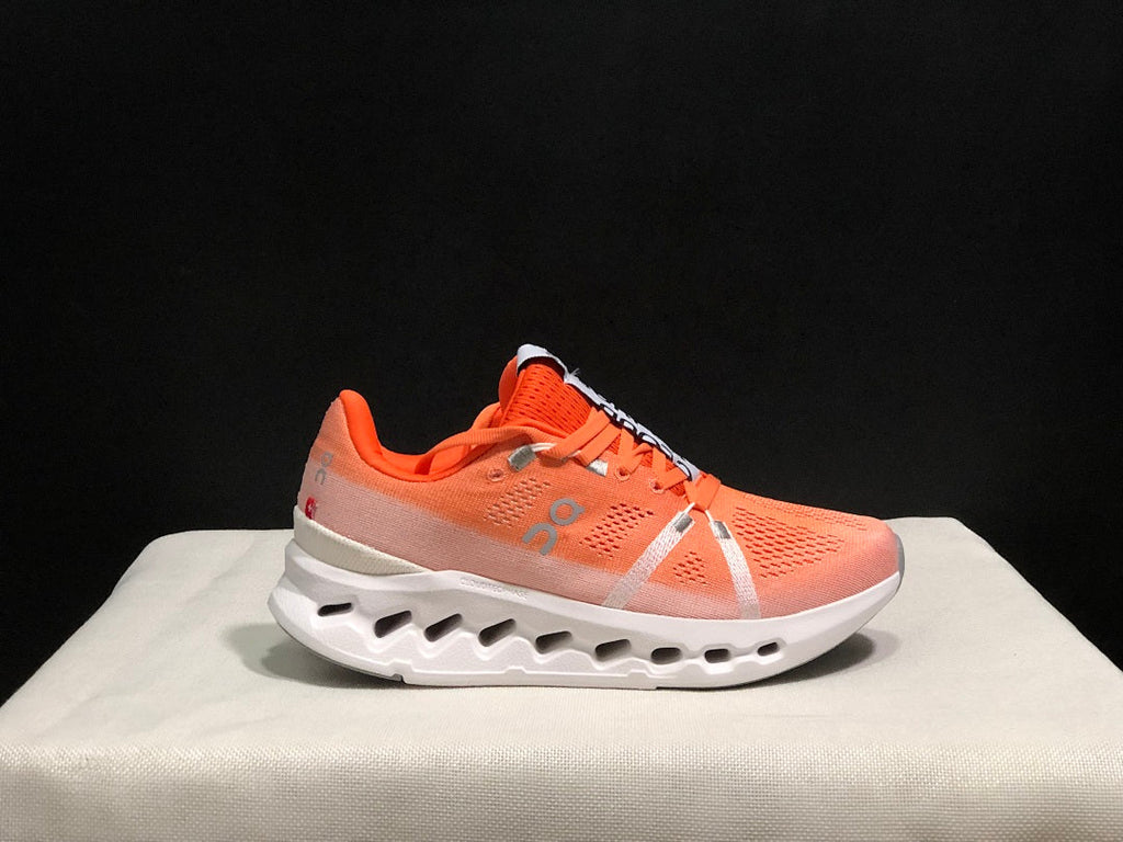 Coral and White On Cloudsurfer Running Shoes - product image from the listing.