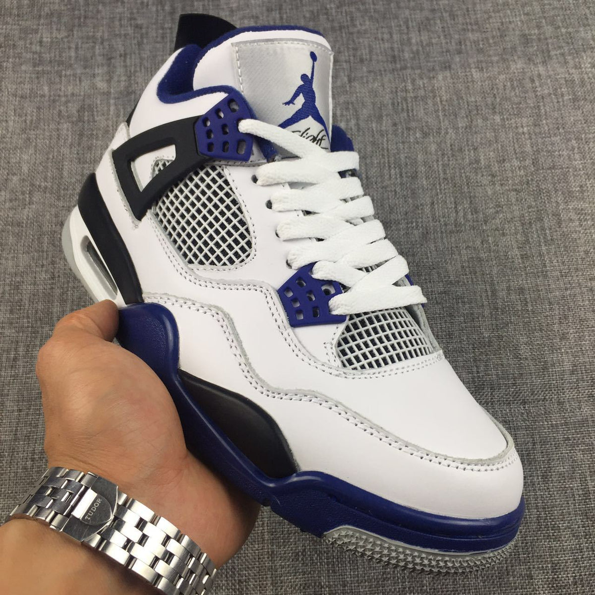 Air Jordan 4 Sneakers in White, Black and Blue - product image from the listing.