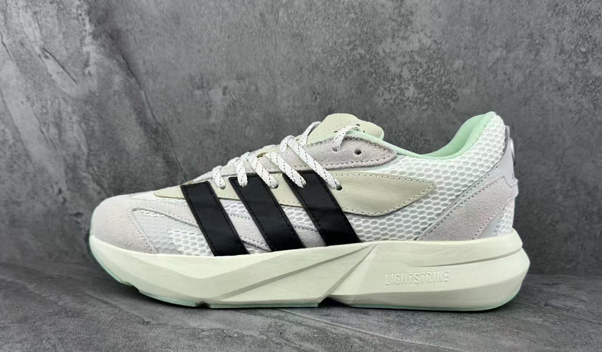 White and Black Adidas Lightstrike Low-Top Sneakers - product image from the listing.