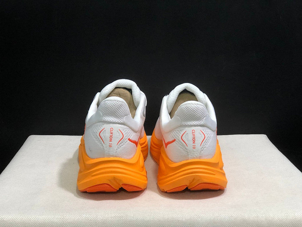 White and Orange HOKA Clifton 10 Running Shoes - product image from the listing.