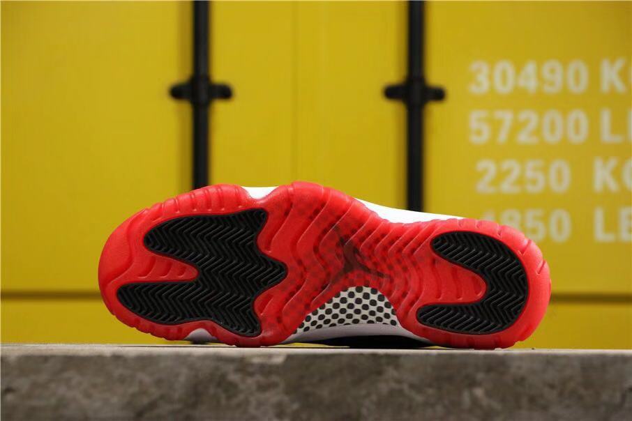 Air Jordan 11 Retro Bred High-Top Sneakers in Black and Red - product image from the listing.