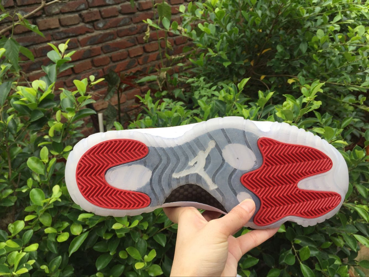 Air Jordan 11 Low Sneakers White Red - product image from the listing.