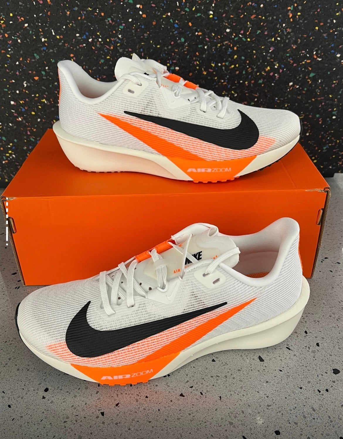 Nike Air Zoom Rival Fly 4 Running Shoes in White Orange FV6040-101 - product image from the listing.