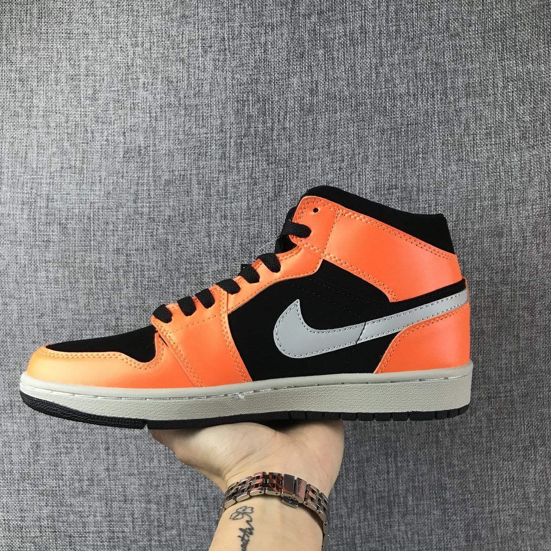Air Jordan 1 Mid Sneakers in Black Orange 554724-062 - product image from the listing.