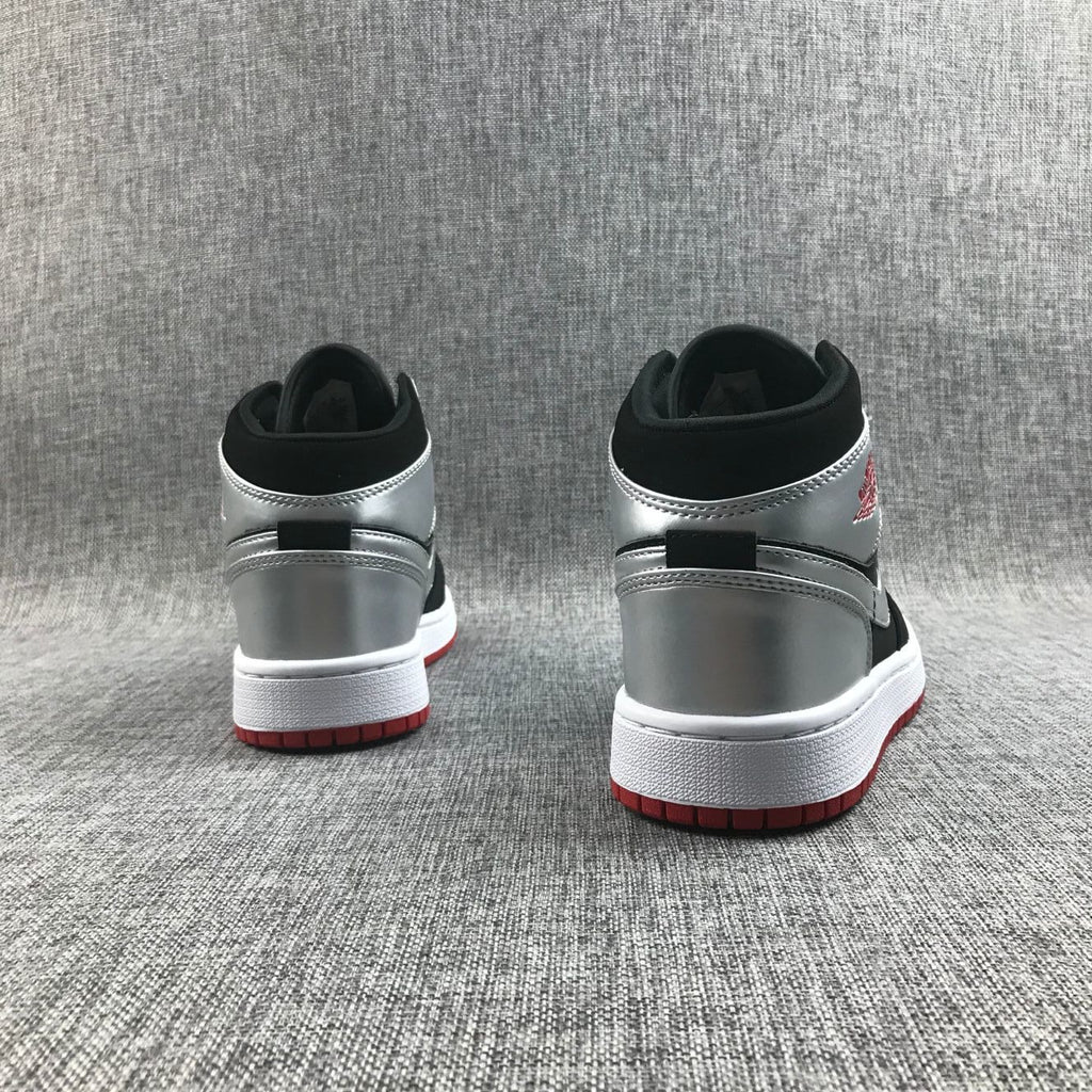 Air Jordan 1 Mid SE GS Sneakers in Black Silver 554725-057 - product image from the listing.