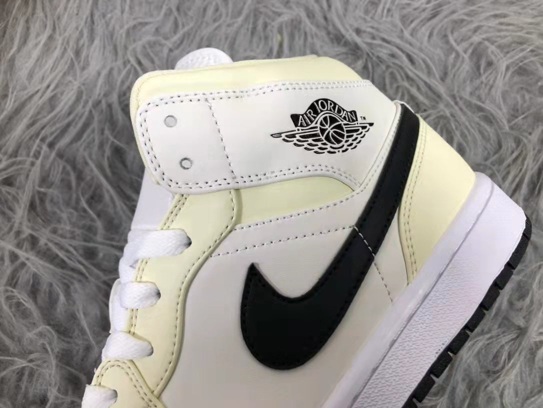 Jordan Air 1 Mid Sneakers in Cream White and Black - product image from the listing.