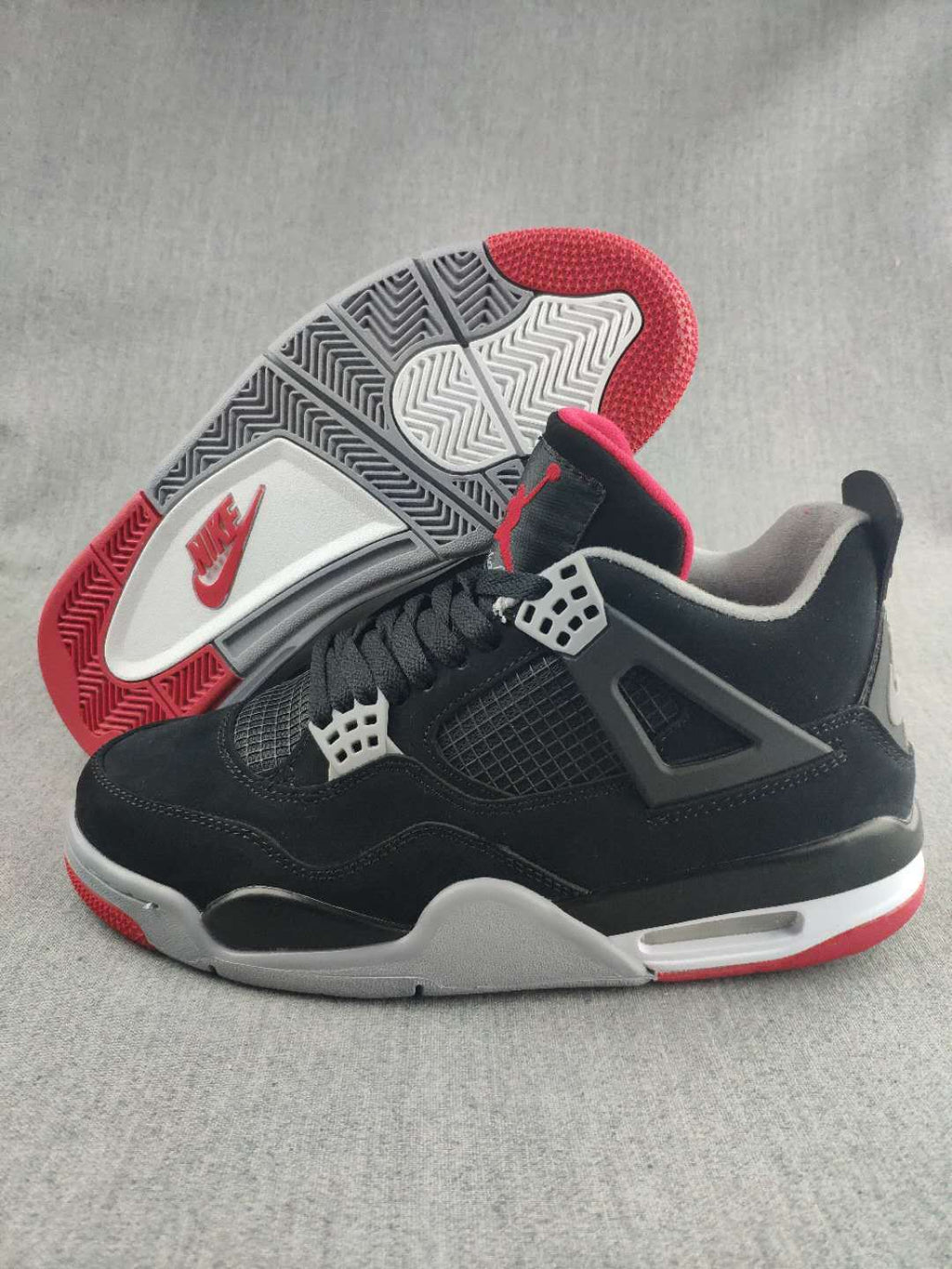 Jordan 4 Retro Sneaker in Black, in Red and White - product image from the listing.