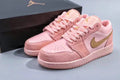 Women's Jordan 1 Low Pink and Gold Sneakers - product image from the listing.