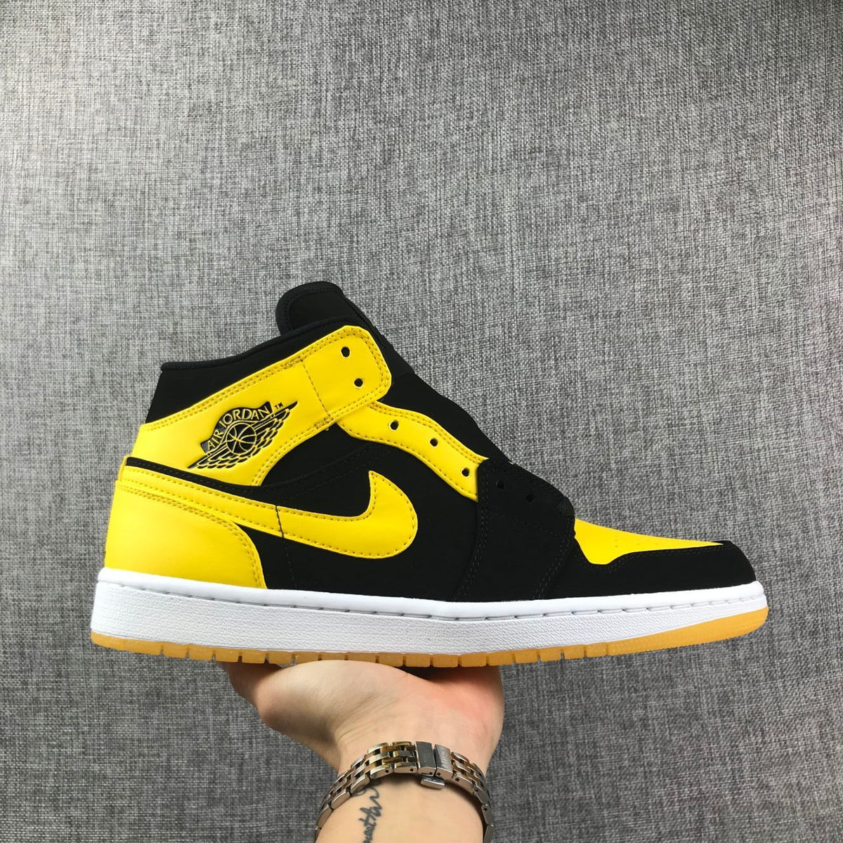 Air Jordan 1 Mid Sneakers in Black and Yellow - product image from the listing.