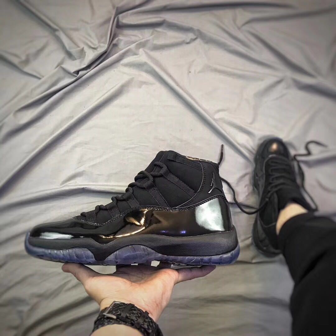 Air Jordan 11 Cap and Gown High-Top Sneakers in Black - product image from the listing.