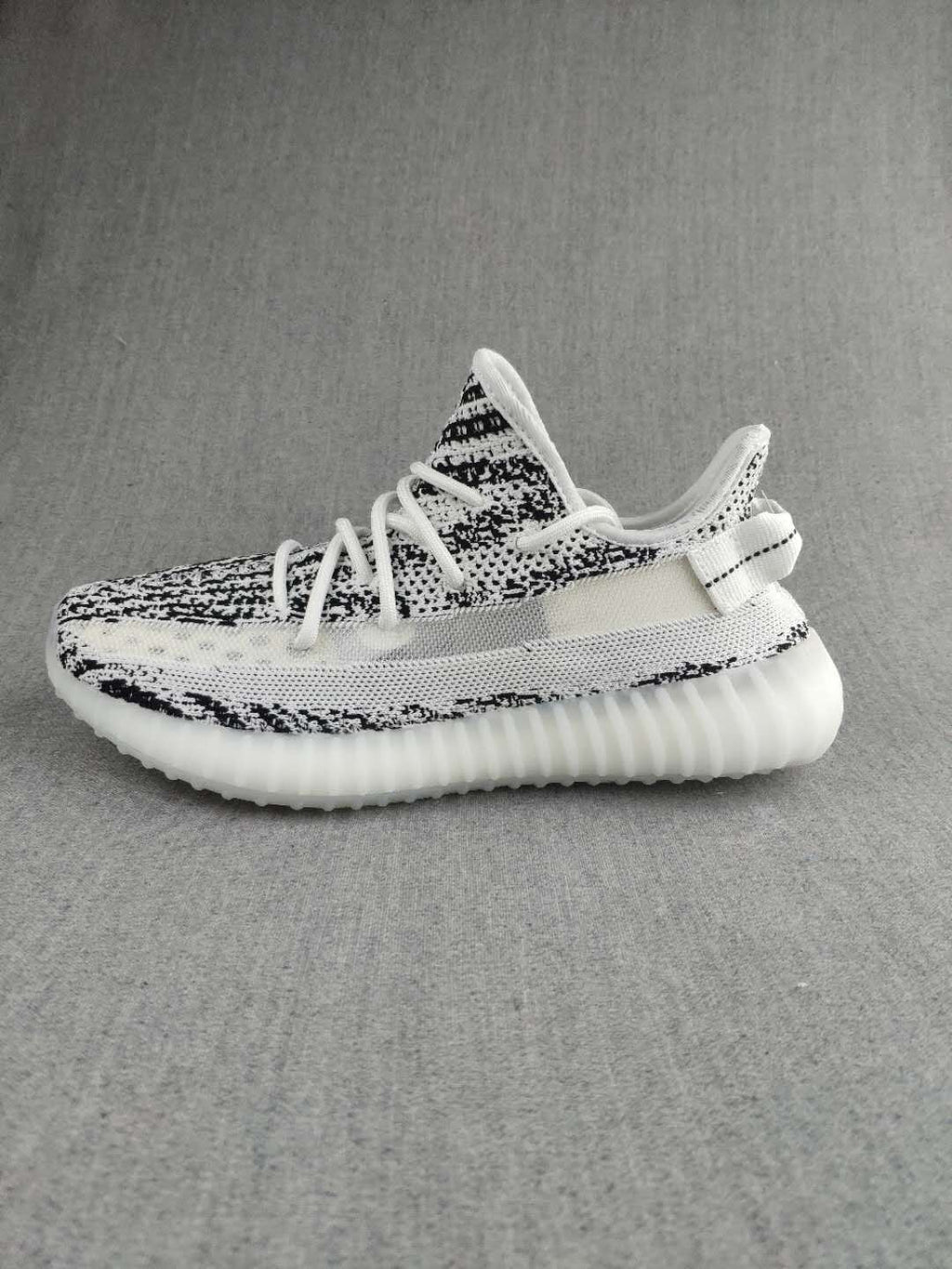Black and White Yeezy 350 V2 Knit Sneakers - product image from the listing.