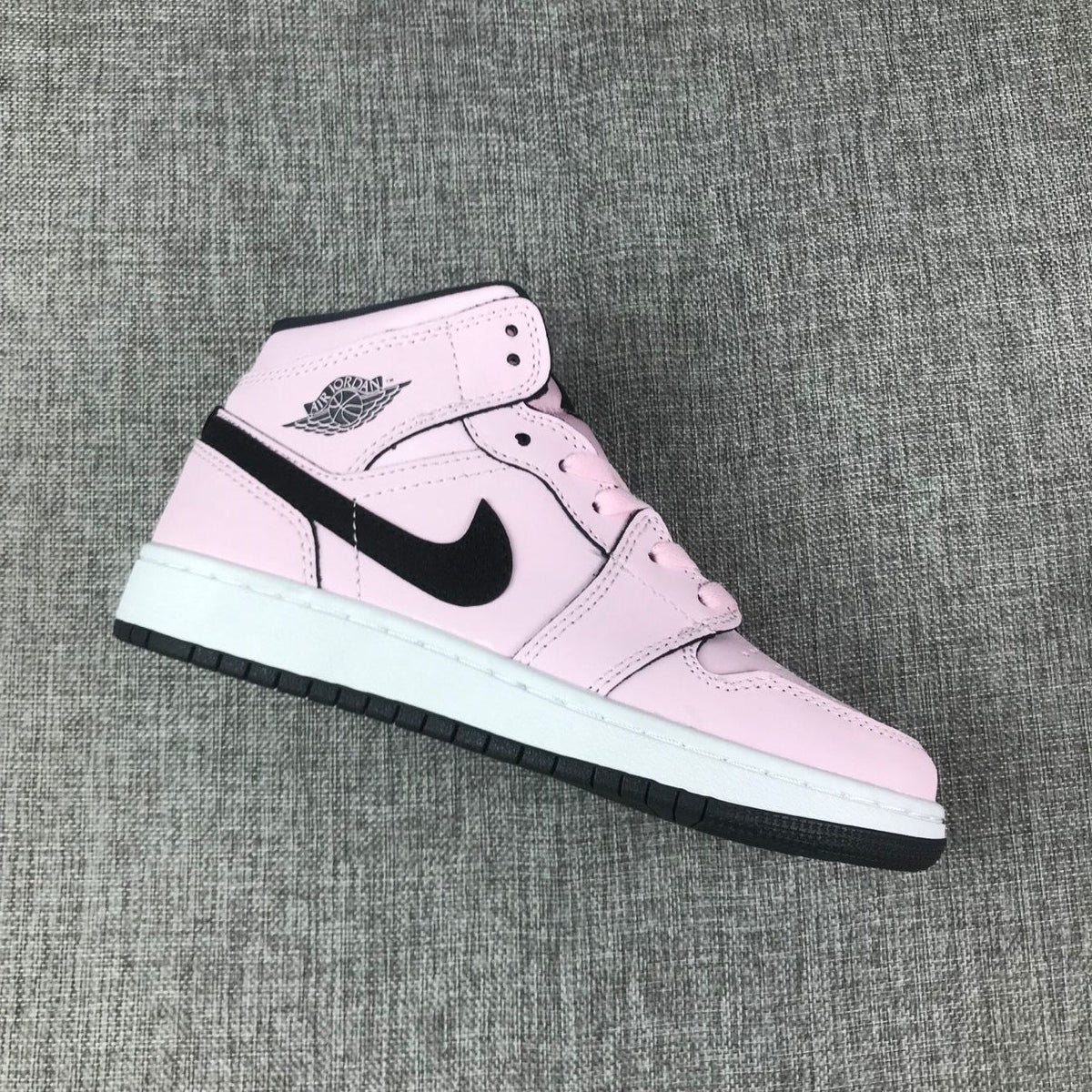 Air Jordan 1 Mid High-Top Sneakers in Pink and Black - product image from the listing.