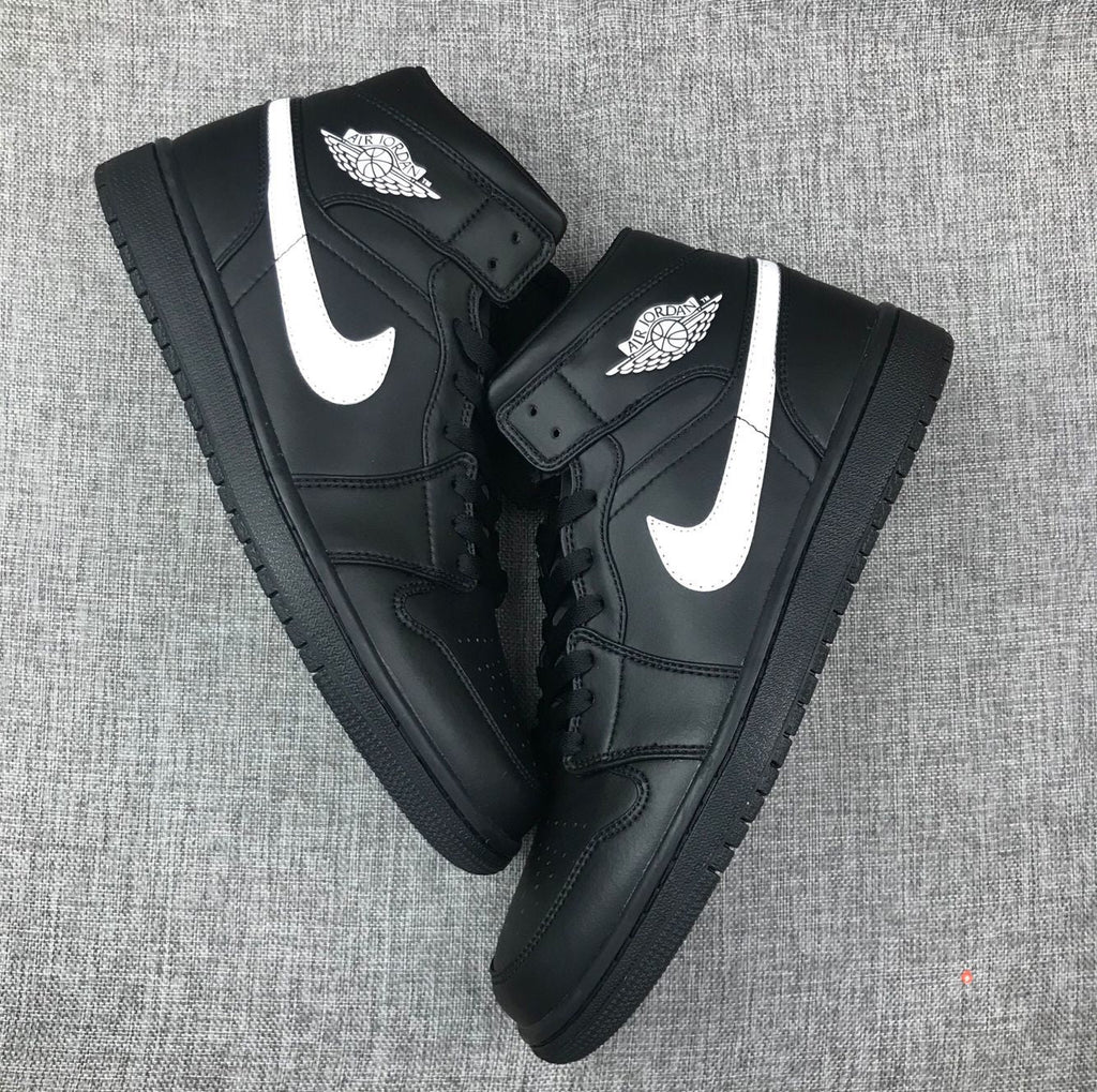 Air Jordan 1 Mid Sneakers in Black White 554724-049 - product image from the listing.