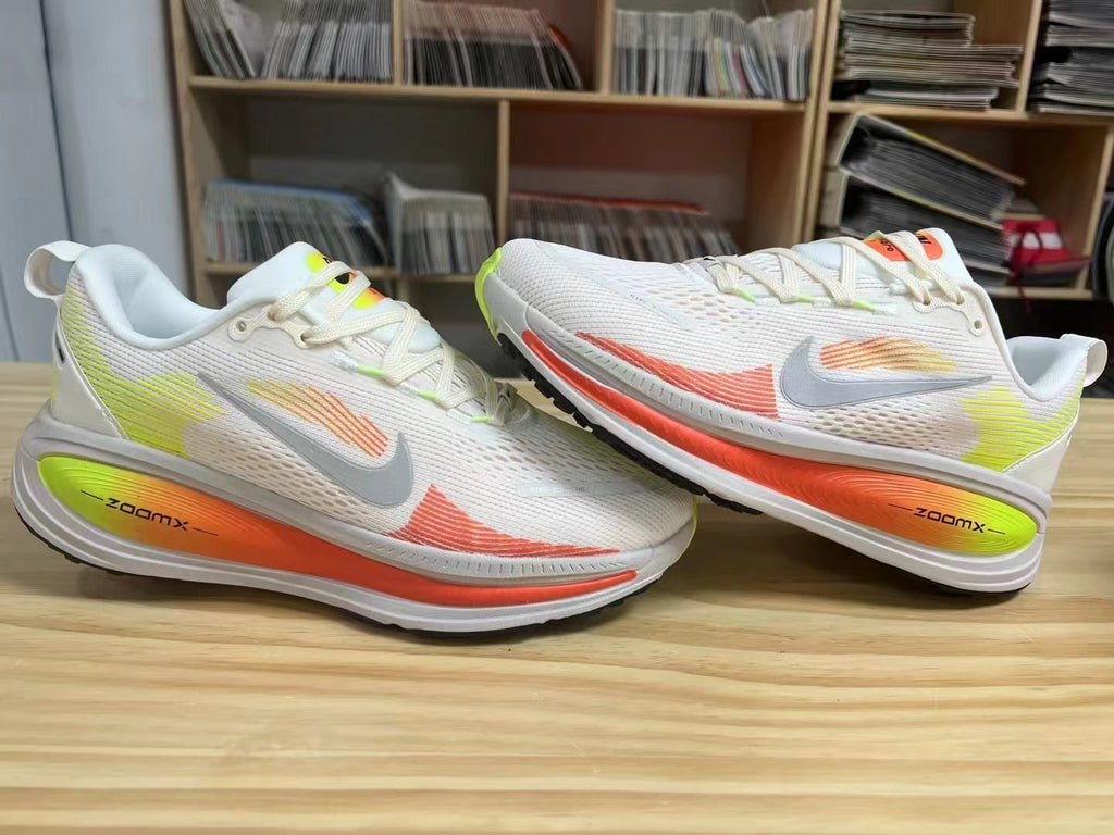 Nike Vomero 18 Running Shoes in White Volt Orange - product image from the listing.