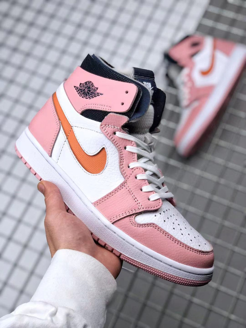 Jordan 1 High Zoom CMFT Sneakers in Pink White Orange CT0979-601 - product image from the listing.