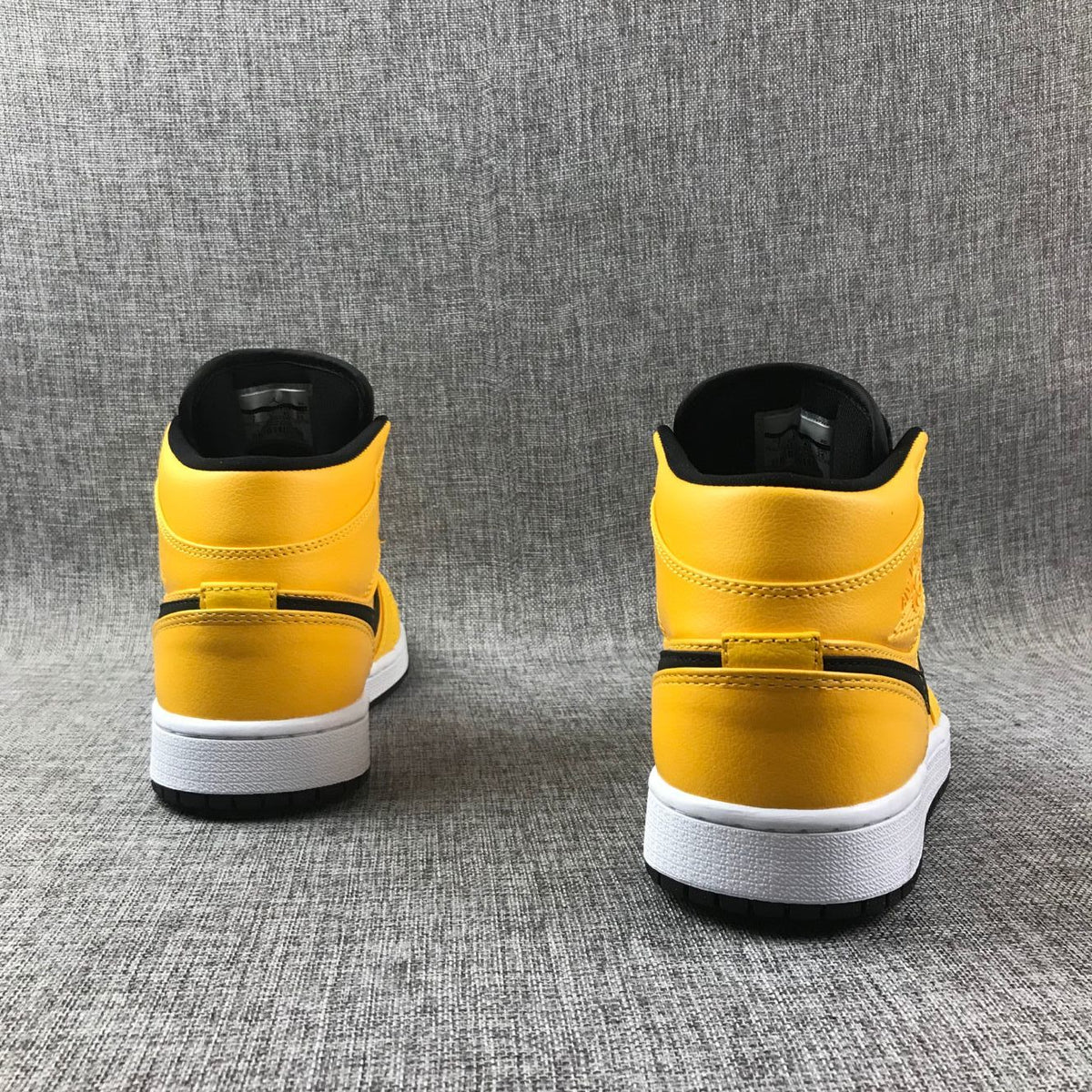 Air Jordan 1 Mid Sneakers in University Gold Black White - product image from the listing.