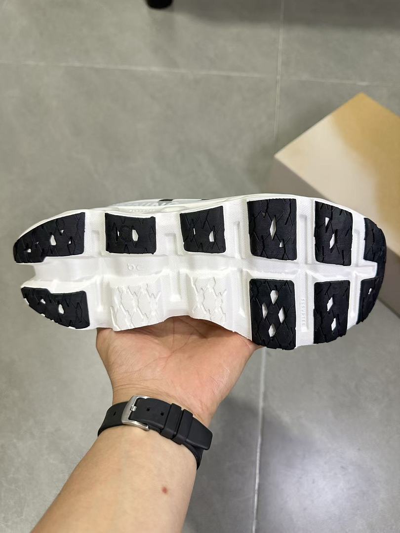On Running Running Shoes in White and Black - product image from the listing.