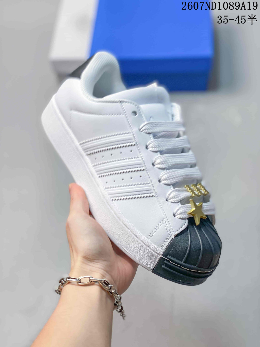 adidas Superstar Shell-Toe Sneakers in Black and White - product image from the listing.