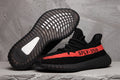Yeezy 350 V2 Sneakers in Black and Red Knit - product image from the listing.