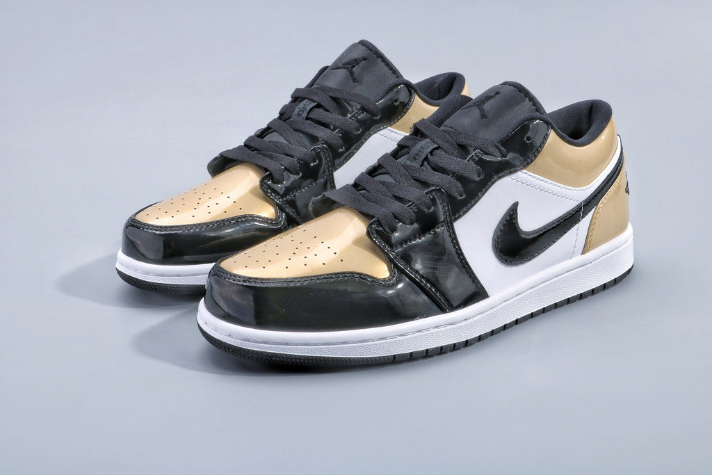 Jordan 1 Low Gold Toe Sneakers in Black and Metallic Gold - product image from the listing.