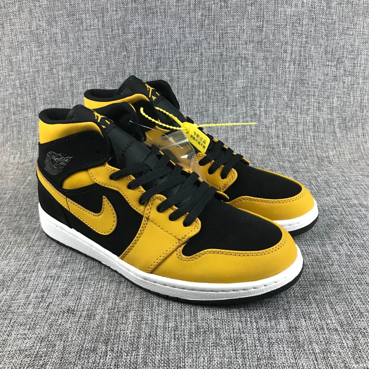 Air Jordan 1 Mid Sneakers in Black and Yellow - product image from the listing.