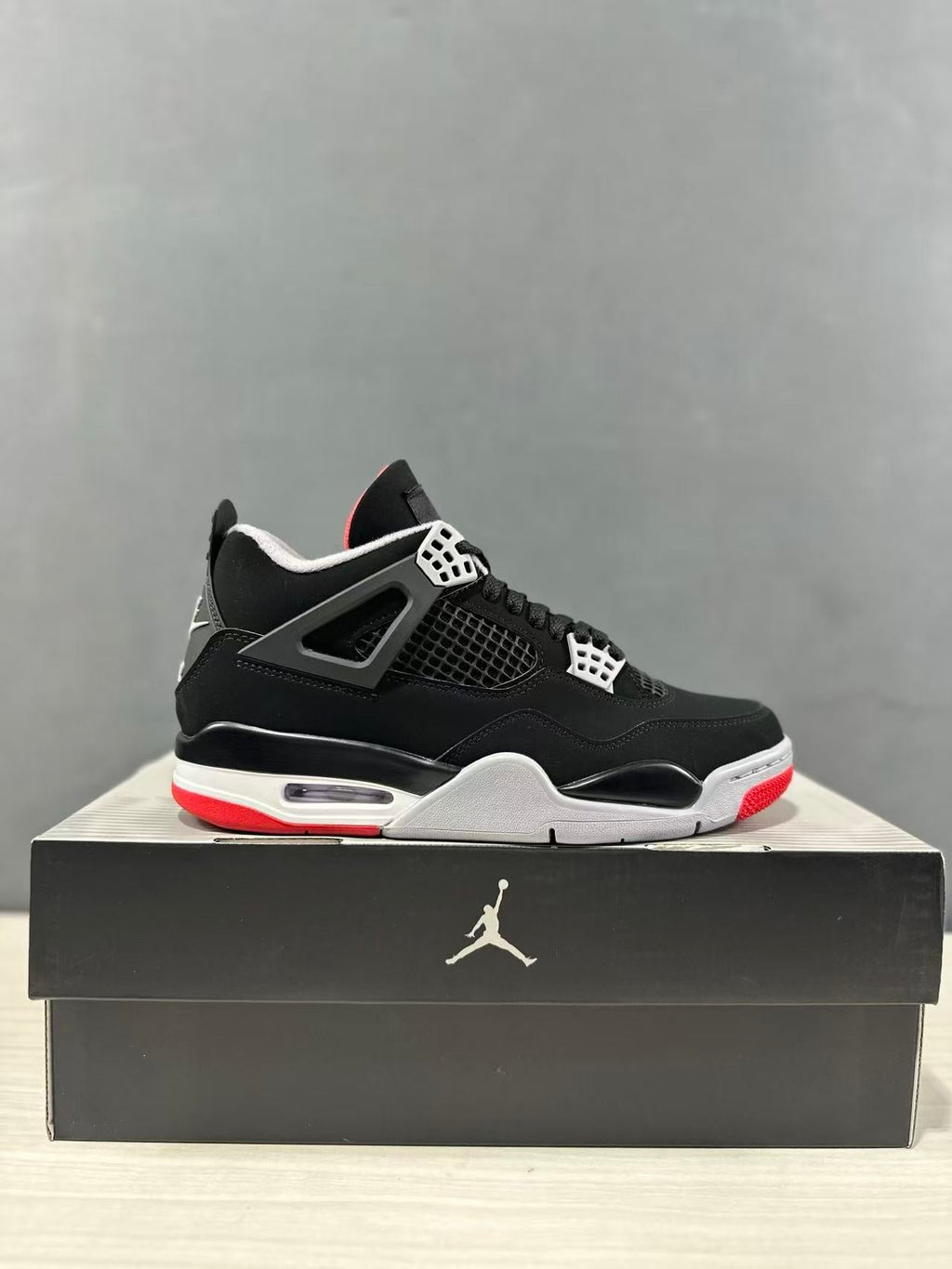 Air Jordan 4 Retro Bred Black Red Sneakers IX8180-001 - product image from the listing.