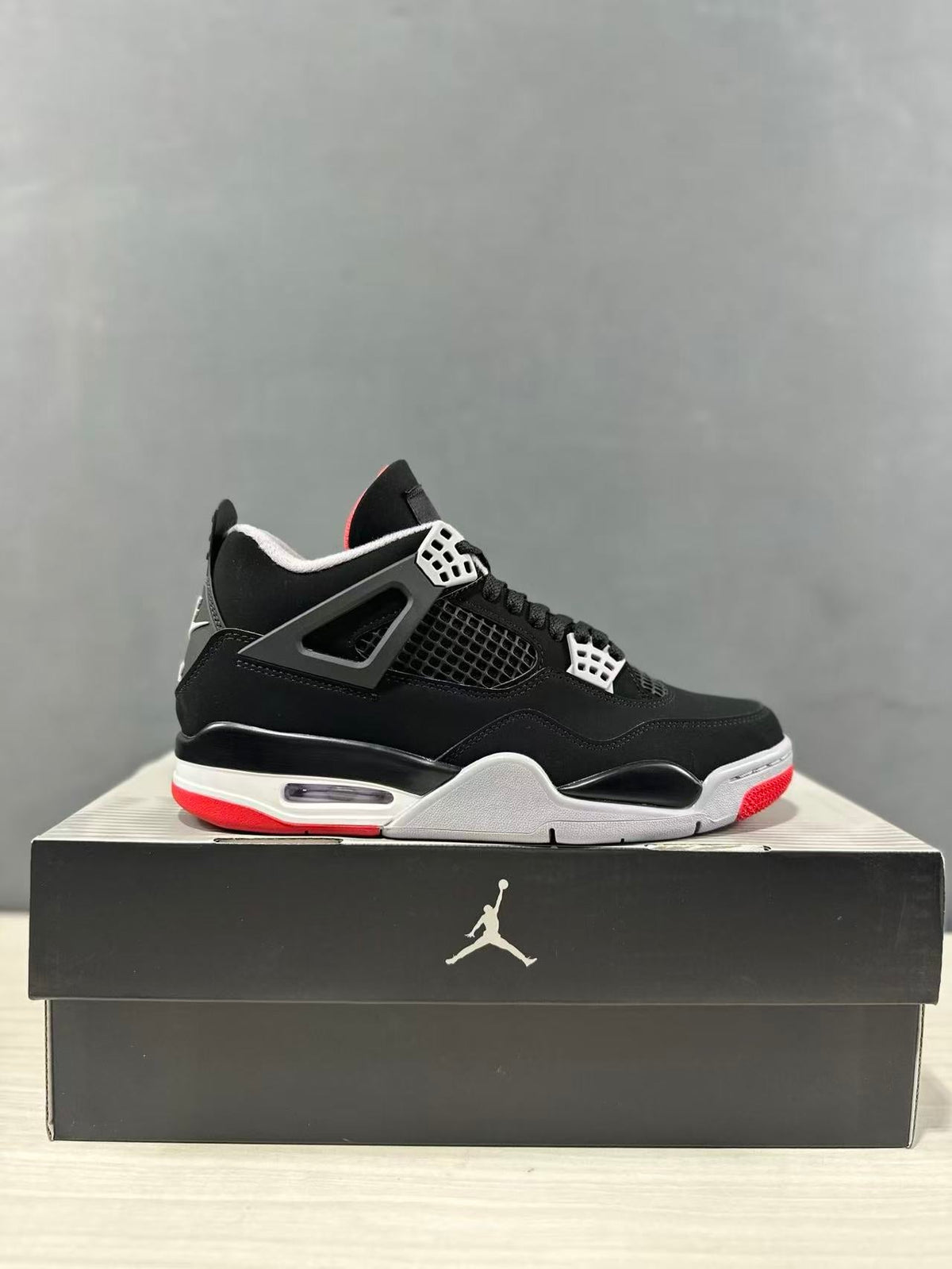 Air Jordan 4 Retro Bred Black Red Sneakers IX8180-001 - product image from the listing.
