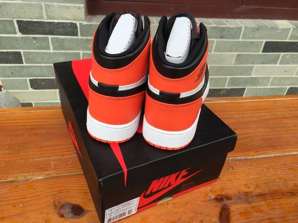 Women's Jordan 1 High Black Orange White Sneakers - product image from the listing.