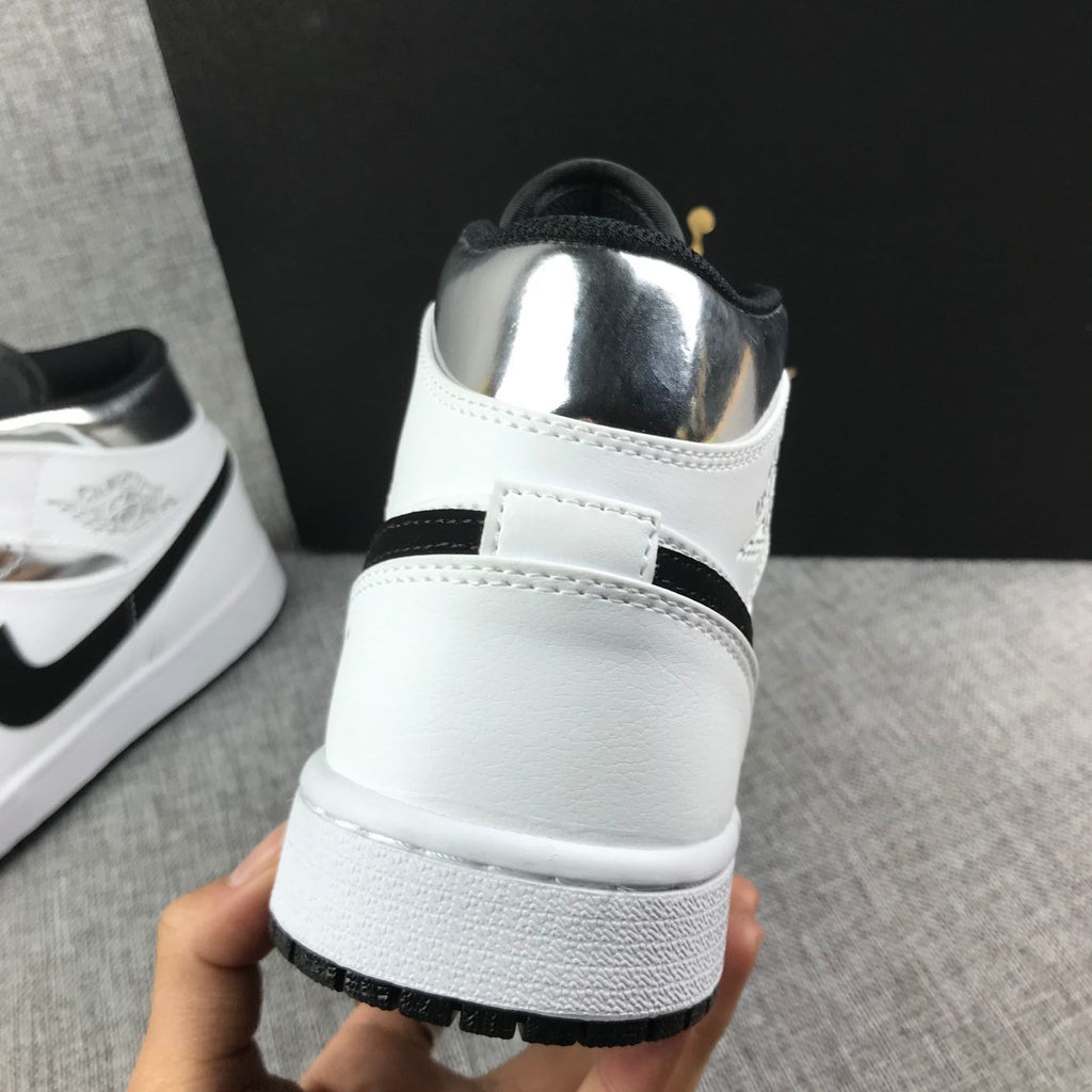Air Jordan 1 Mid Sneakers in White and Black - product image from the listing.