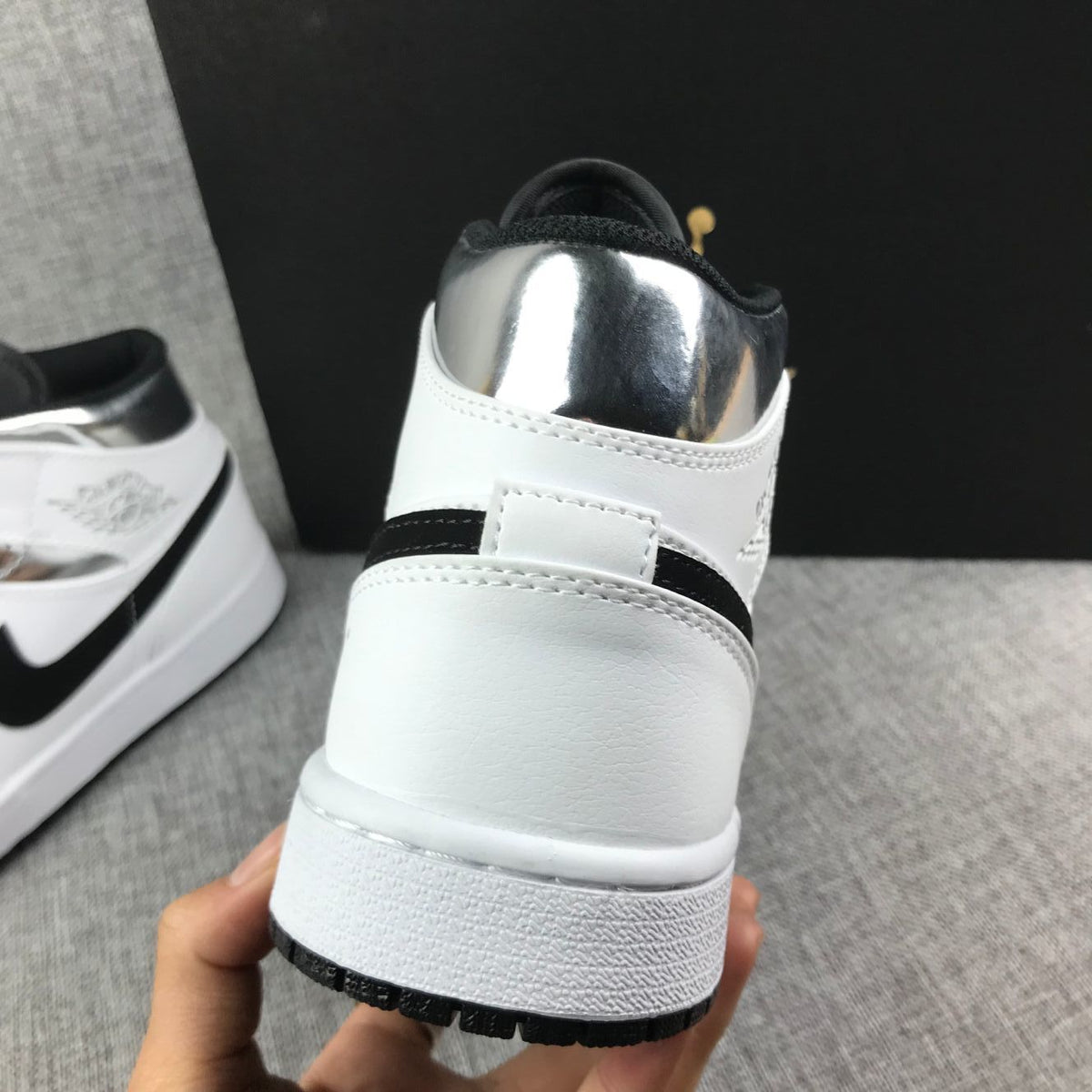 Air Jordan 1 Mid Sneakers in White and Black - product image from the listing.
