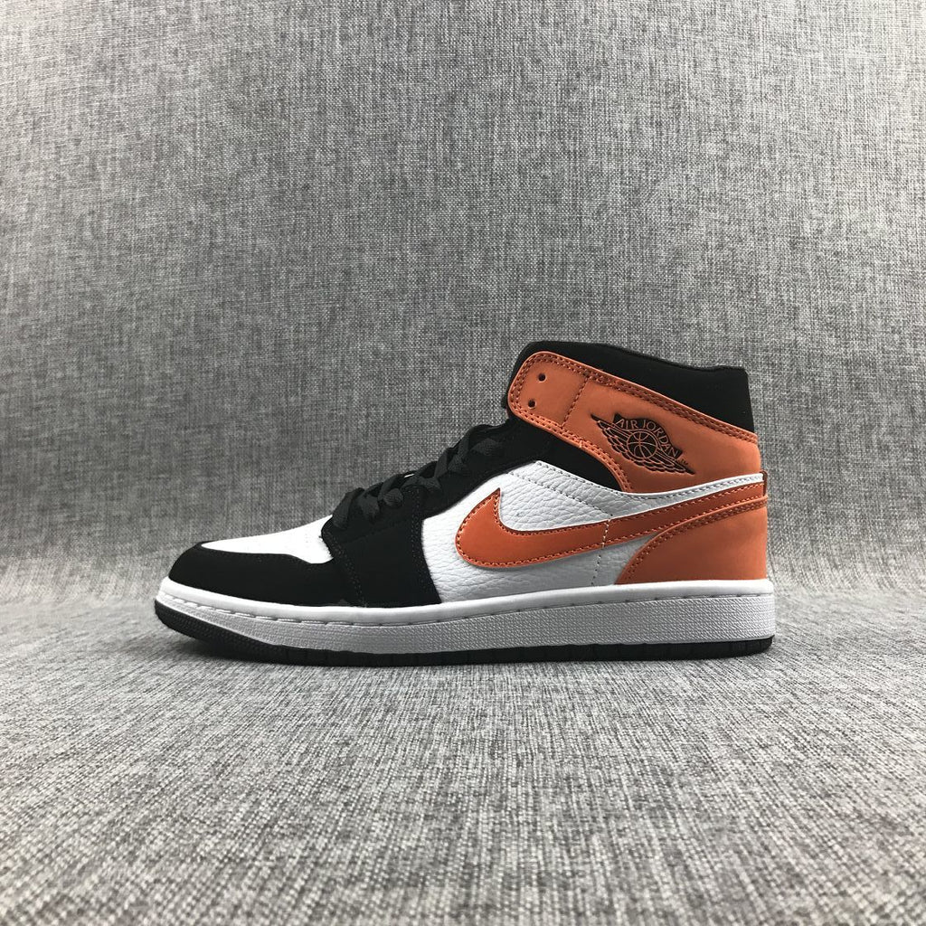 Air Jordan 1 Mid Sneakers in Black White Orange 554724-058 - product image from the listing.