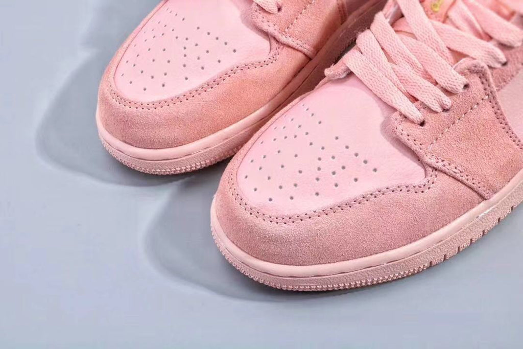Women's Jordan 1 Low Pink and Gold Sneakers - product image from the listing.