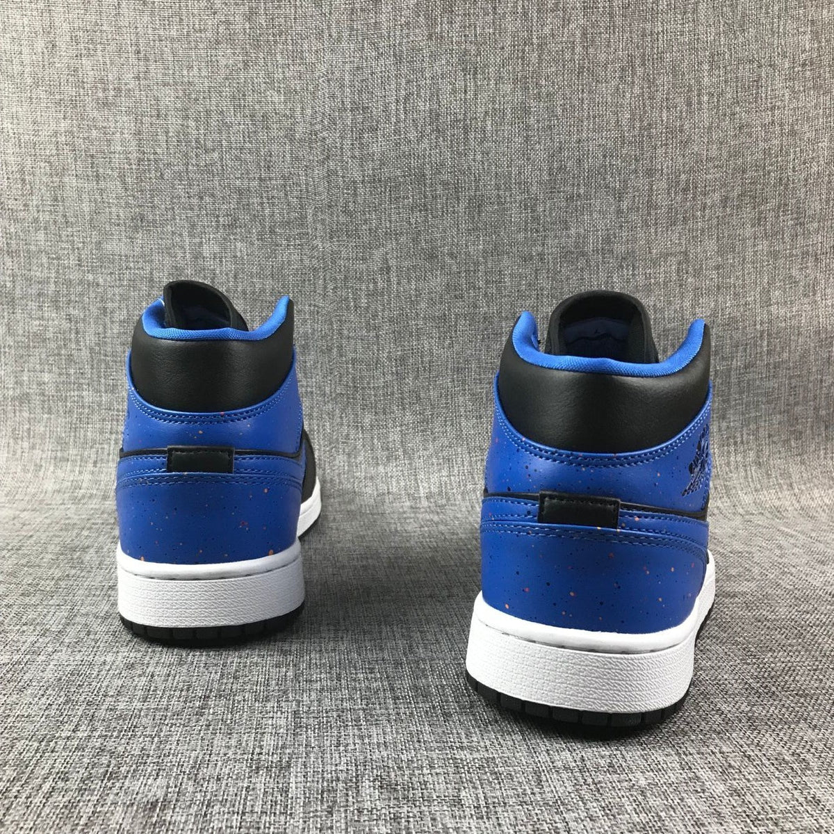 Air Jordan 1 Mid High-Top Sneakers in Black and Blue - product image from the listing.