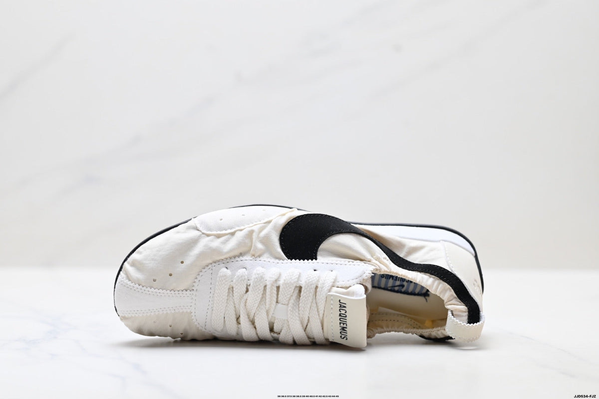 Jacquemus x Nike Jacumoon Low-Top Sneakers, in White and Black - product image from the listing.