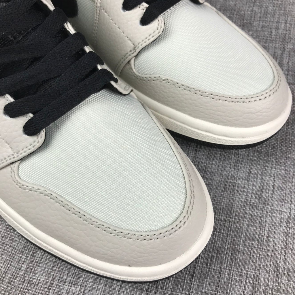 Air Jordan 1 Mid High-Top Sneakers in Grey and Black - product image from the listing.