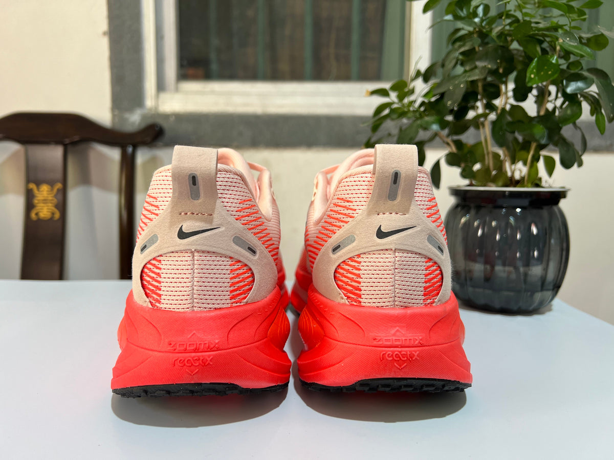 Cream and Coral Nike Vomero 18 Running Shoes - product image from the listing.