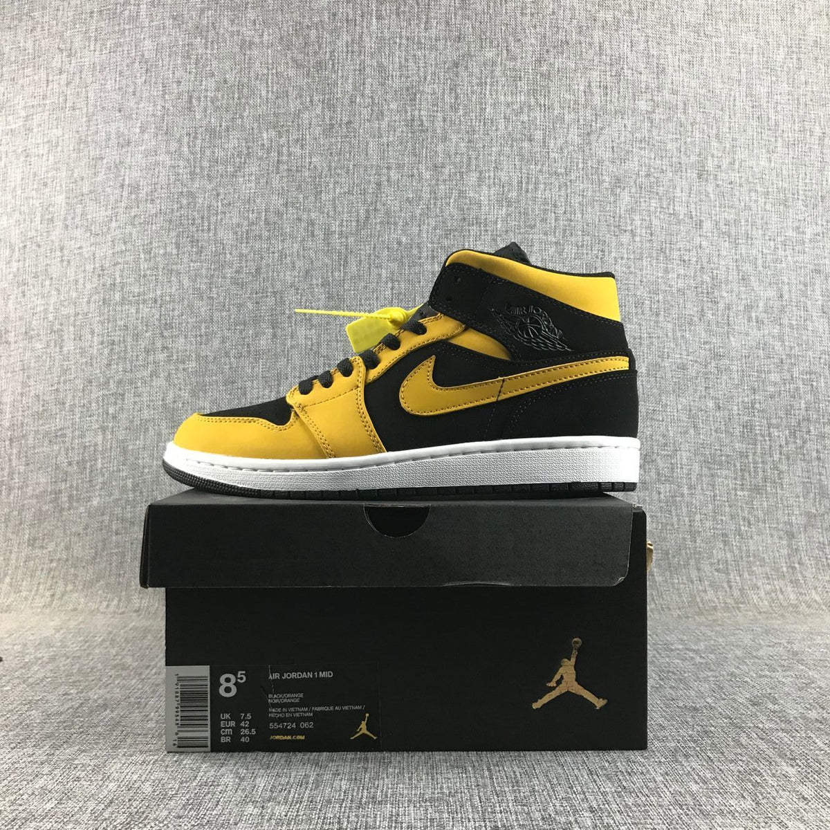 Air Jordan 1 Mid Sneakers in Black and Yellow - product image from the listing.